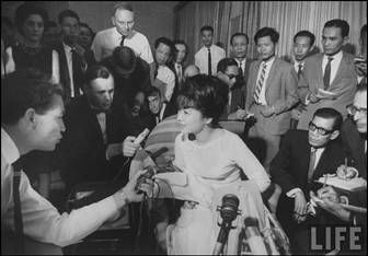 Photo1: VIETNAM  SEPTEMBER 1 1: Madame Dinh Nhu Ngo (C) taking to the press at the airport as she is leaving for Europe. (Photo by Larry Burrows/Time & Life Pictures/Getty Images. The LIFE Picture Collection)
